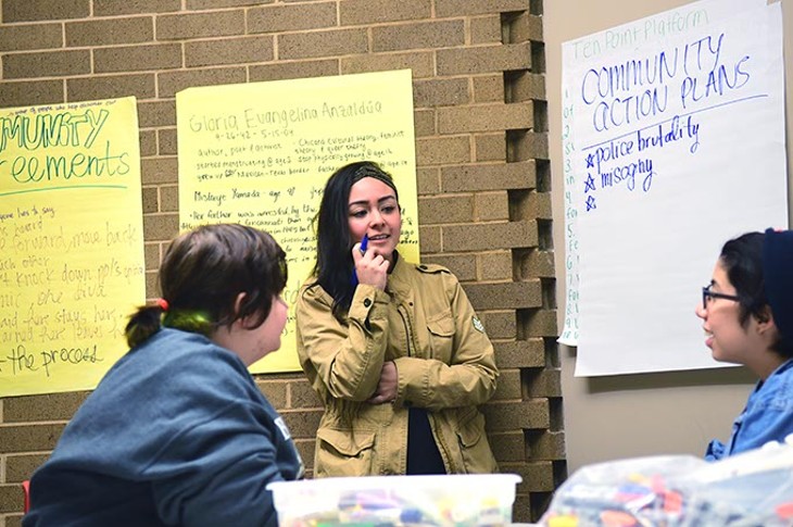 Making HERstory, Lena Khader leads a group discussion at the Western Oaks Library, Thursday, 12-11-14.  mh