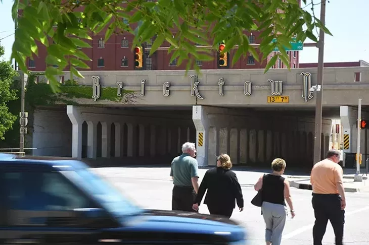 Pedestrians on their way to Bricktown cross E.K. Gaylord Boulevard at Sheridan near the train overpass, underwhich the new Maps Streetcars will pass. mh