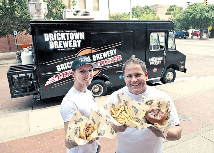 Left, Ryan Reynolds and Blake Lippert with hotdogs, fries and Burgers, surved by the Truckburger truck, parked behind them in Bricktown.  mh