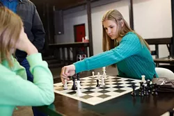 Veronika Zilajevs plays against her younger sister Victoria during a ladies' chess club meeting at District House in Oklahoma City, Saturday, Feb. 30, 2016. - GARETT FISBECK