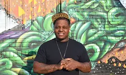 Jabee, local hiphop artist, photographed in front of the parking lot mural off NW 9th Street east of Broadway Avenue, in OKC, 8-26-15. - MARK HANCOCK