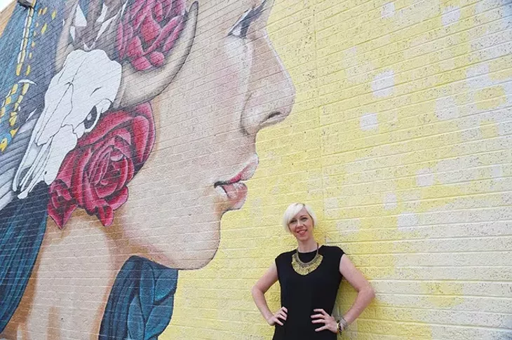 Muralist and art director Erin Cooper with work she co-created on the north wall of what was Bruno's Furniture, now K&N Interior Consignment, on N. Western Avenue, 9-30-15. - MARK HANCOCK