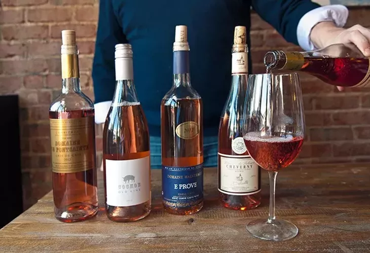 Ian Clarke of Putnam Wines pours a glass of Travel next to other rose wines at Ludivine recently. mh
