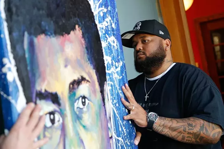 Robert Peterson hangs his art at JRB Gallery in Oklahoma City, Thursday, April 2, 2015. - GARETT FISBECK