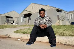 Jabee poses for a photo in front of a duplex where he lived in Oklahoma City, Wednesday, Dec. 2, 2015. - GARETT FISBECK