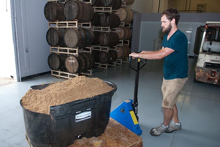 Anthem Brewing Company's brewer Will Perry moves used mash from the fermentation vessels. (Mark Hancock)