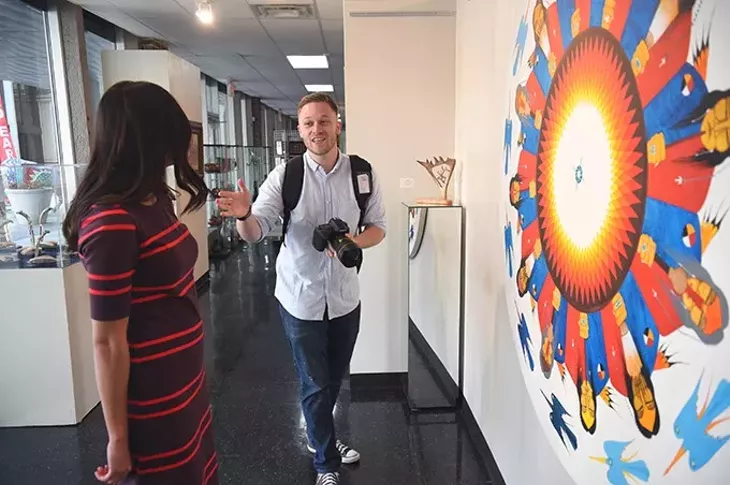 Caleb Everett is the new multimedia content manager at the OKC Convention & Visitors Bureau, shown working with his wife, Sarah Everett he is using as a model while photographing artwork to compliment video already shot at the Red Earth Museum in Downtown Oklahoma City, 1-2-15. - MARK HANCOCK