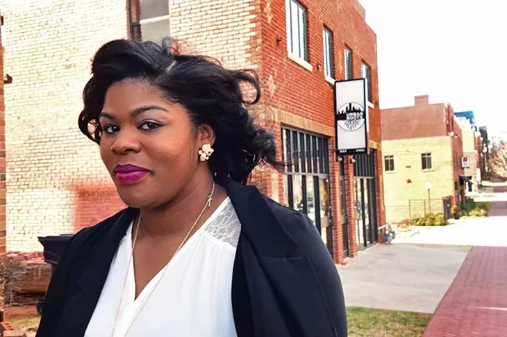 Ashley Stevenson owner of Foodie Foot Tours, outside Urban Roots and across from Deep Deuce Grill, in Deep Deuce which will be an up-comming destination for her foot tours. mh