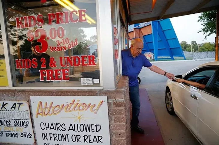 Lindy Shanbour sells tickets at the Winchester Drive In Theatre in Oklahoma City, Monday, June 22, 2015. - GARETT FISBECK