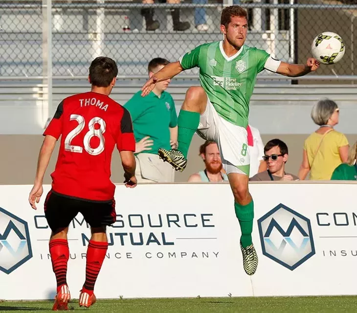 Oklahoma City's Michael Thomas (8) goes against Portland's Andy Thoma (28) during a game between Energy FC and T2 at Taft Stadium in Oklahoma City, Friday, June 5, 2015. - GARETT FISBECK