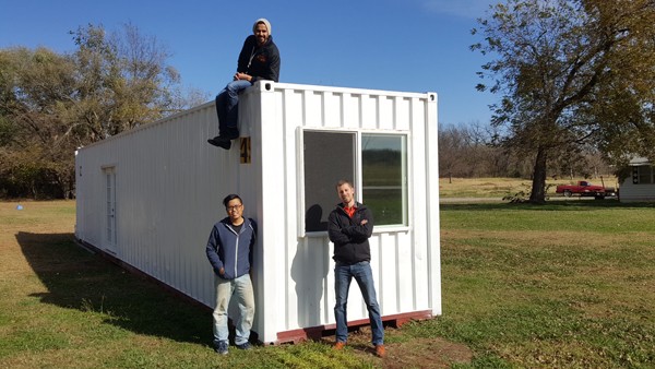Clockwise from lower left, Ben Loh, Swapneel Deshpande, and Lee Easton, with the prototype ModernBlox container home in Stillwater. - PROVIDED