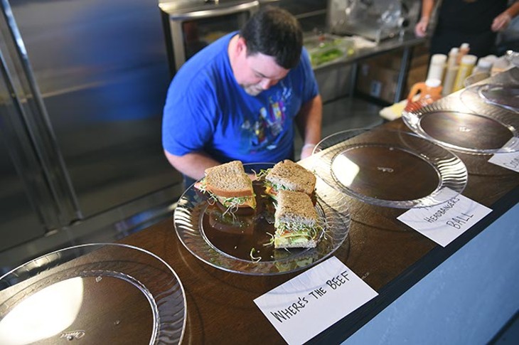 Isaac Barton is busy behind the counter making sandwiches during a soft opening of their new shop, The Sandwich Club, Friday, 6-12-15, at 3703 N. Western. - MARK HANCOCK