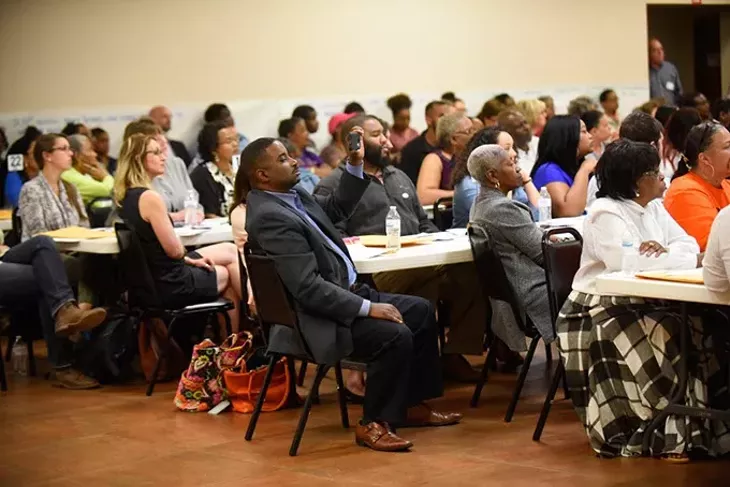 Community members listen during a OKCPS Charter School expansion meeting at Fairview Missionary Baptist Church, Tuesday, April 5, 2016. - GARETT FISBECK