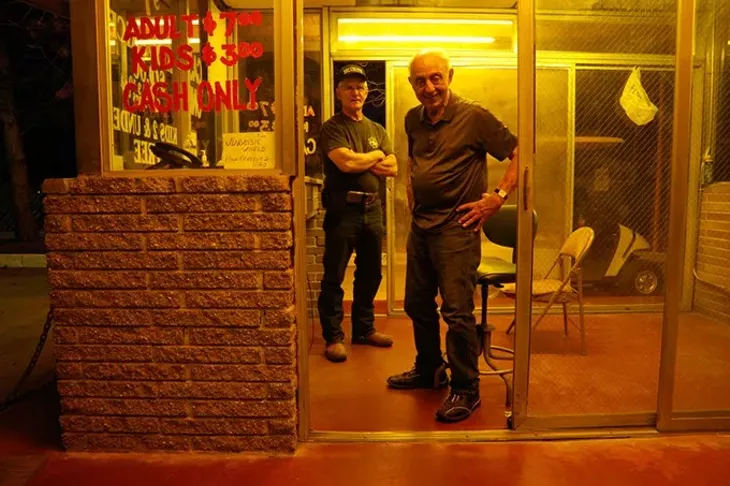 Lindy Shanbour, right, and Bob Deupree, left, run the ticket booth at the Winchester Drive-In. - GARETT FISBECK