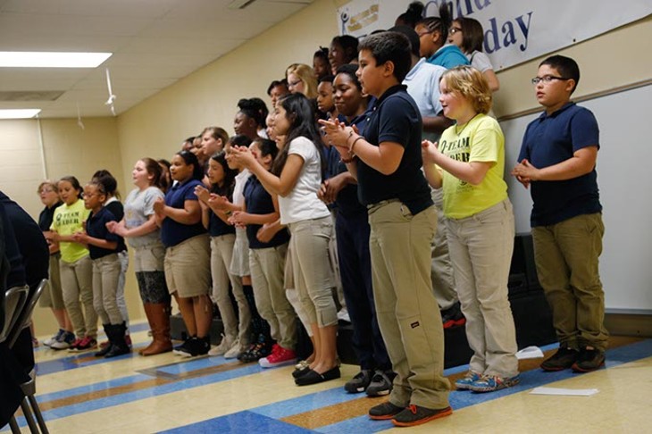 A youth choir performs during a ceremony at Bodine Elementary School in Oklahoma City, Monday, May 11, 2015. - GARETT FISBECK