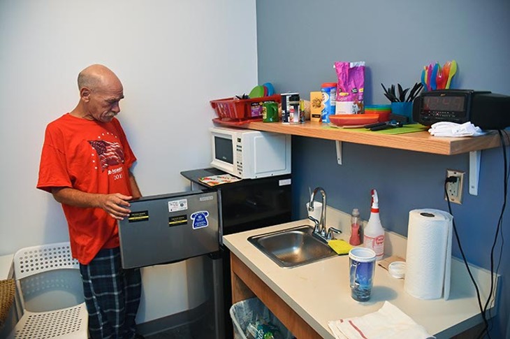 Randy Brown seems to enjoy the amenities at his new home in the West Town Apartments, on the property of the WestTown Homeless Resource Campus in Oklahoma City, 9-21-15. - MARK HANCOCK