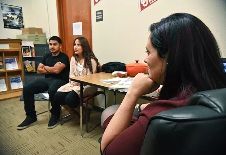 Katie Morgan, teen parent coordinator for OKCPS, listens to teen mother and father, Stephanie Morga and Humberto Herrera, both Seniors at Captiol Hill High School, 11-18-15. - MARK HANCOCK