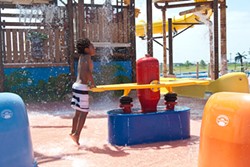 A boy gets down with the water toys at Andy Alligator's water park recently.