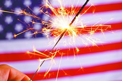 sparkler and usa flag showing 4th of july - BIGSTOCK