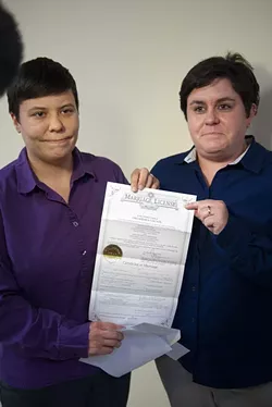 First gay couple to get their marriage license at the Ok. County Courthouse, Sara Yarbrough, left, and Lauren Tidwell, display their Marriage License at the Coutny Courthouse Monday, 10-6-14. mh