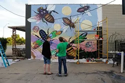 Ben Stookey, left, and Scott Henderson work on a mural outside Antique Avenue in Oklahoma City, Monday, Oct. 26, 2015. - GARETT FISBECK