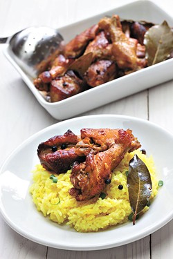 chicken and pork adobo over yellow rice, filipino food - BIGSTOCK