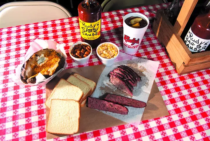 Spread of Rudy's Country Store and Bar-B-Q goodies includes baked potato, beans, cream corn, and Brisket, and of course Rudy's Sissy Sause. mh