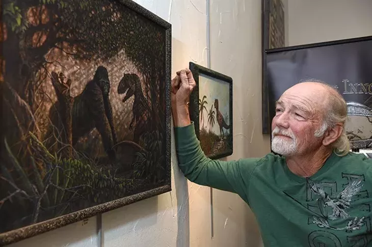 Tony Trammell with his work "King Kong", on the wall at Planet Dorshak gallery on The Paseo. mh