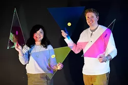 Anh Weber and Adam Edge with dichroic film on acrylic, used to create a faceted fabric, at HSE Architects. (Garett Fisbeck)