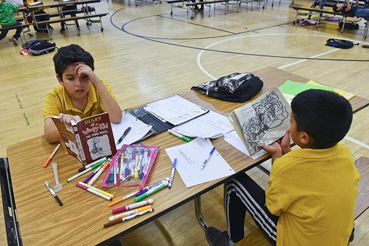 Two boys at Santa Fe South elementary, an OKC Charter School, read books during a Boys and Girls Club After school program, 11-9-15. - MARK HANCOCK
