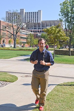 Dillon Hollingsworth, sports editor at the Oklahoma Daily, heads back to the newsroom from the weekly news conference with coach Bob Stoops across the University of Oklahoma campus, 9-28-15. - MARK HANCOCK