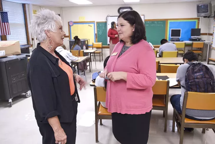 Aurora Lora, right, meets with Emerson Alternative School's principal, Sherry Kishore, in one of the classrooms. mh