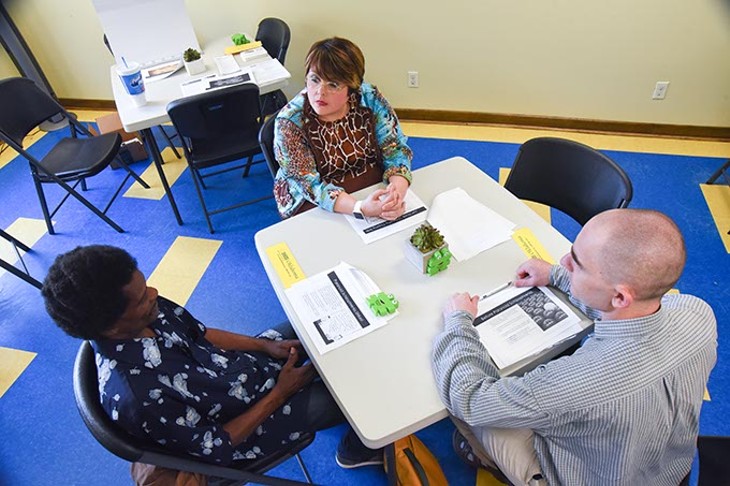 Augusta Cox speaks with Calvin Lewis, left, and Aaron Formhals during a Wellness Workshop at Lottie House, Wednesday, 7-5-15.  mh