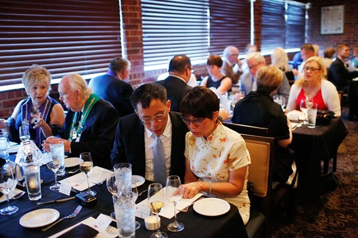 Members wait to dine during a meeting of The Chaine des Rotisseurs at Opus Prime Steakhouse in Oklahoma City, Saturday, July 25, 2015. - GARETT FISBECK