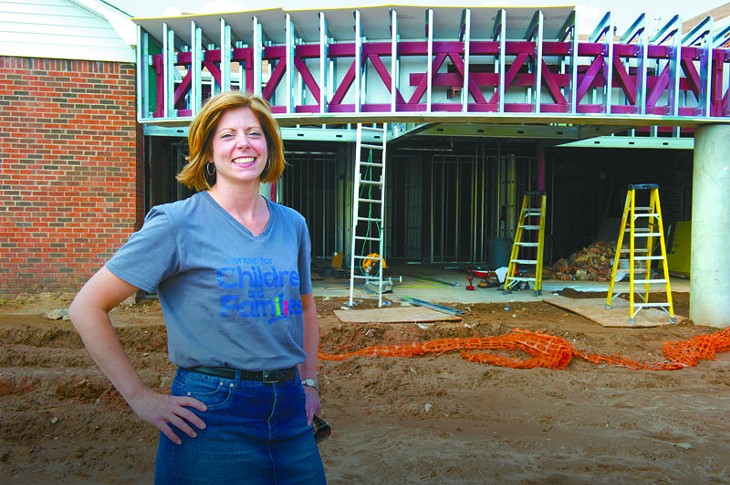 Katie Fitzgerald, executive director for Center for Children and Families stands near the entrance of their new construction site in Norman. Proceeds from Tour de Vin will benefit the non profit organization. Photo/Shannon Cornman - SHANNON CORNMAN