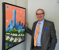 Peter Dolese, Arts Council of OKC Executive Director, with this years festival poster art, in their offices, 6-30-15.  mh