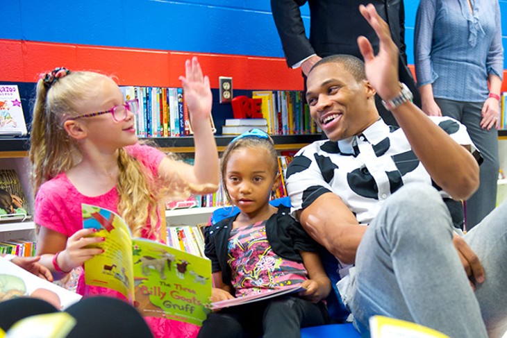 Russell Westbrook stops into "Russell's Reading Room" to read books with children at North Highland Elementary.Photo/Shannon Cornman - girls are Lillian left, and Ayana, right.