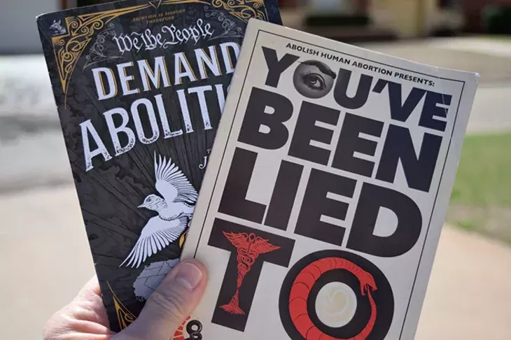 Abolitionist Society of Oklahoma demonstrators hand out fliers like these to just about anyone who will take them. “We want information in the hands of people,” said co-founder Katherine Hunter. (Brett Dickerson / For Oklahoma Gazette)