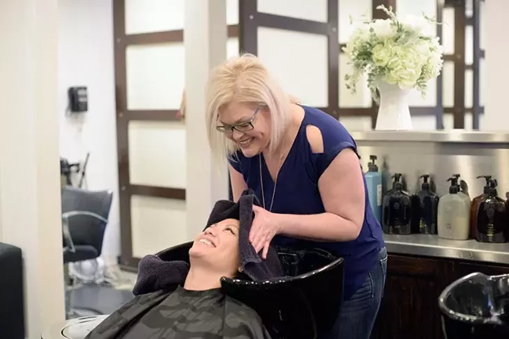 Malisa Osborne washes Theresa Pham hair at Van Cleefs Salon, Wednesday, Feb. 22, 2017. - GARETT FISBECK