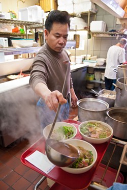 Duy Tran cooks everything from scratch in the kitchen at Pho Cuong.  mh