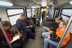Passengers get comfortable near the rear of the Route 5 bus as it continues to board at the Embark downtown transite station, 3:30 pm, 11-20-15. - MARK HANCOCK