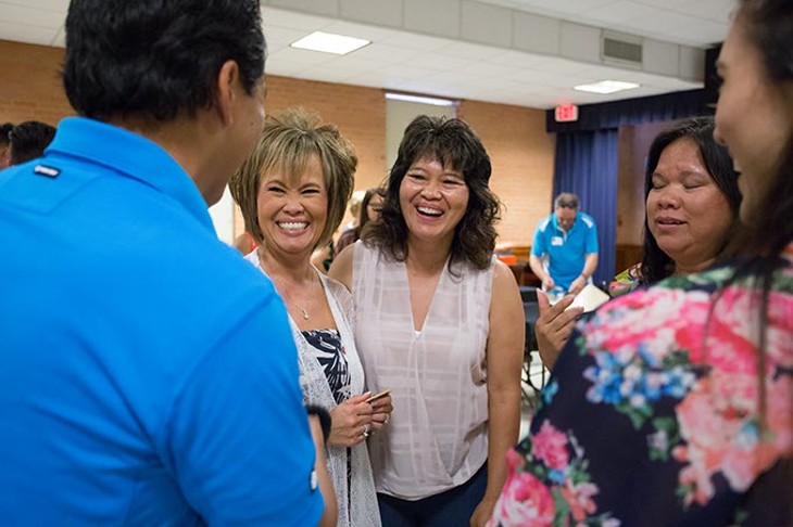 A small group of the 23 children, now adults, share a laugh. Gisela Huyssen and her husband Ulrich Huyssen adopted 23 Vietnamese children to American families at the end of the Vietnam war on Saturday, July 2, 2016 in Oklahoma City. - EMMY VERDIN