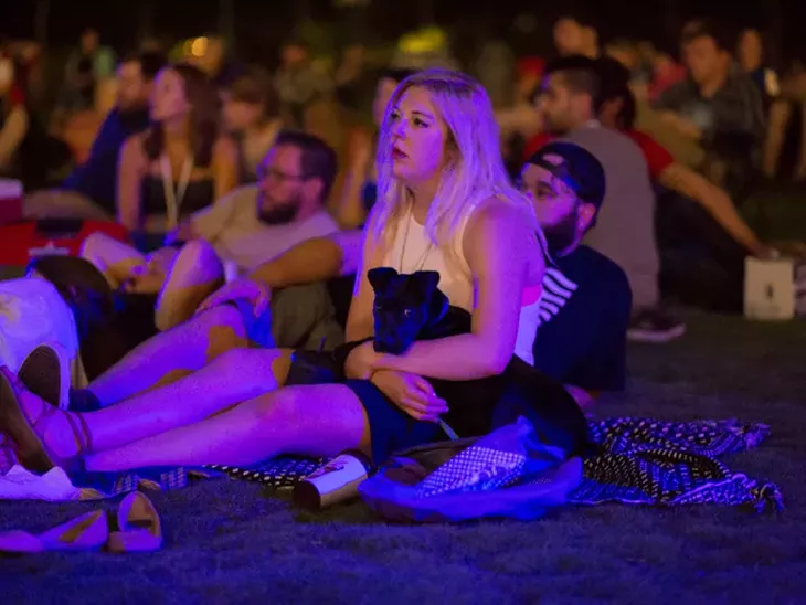 People sit on the lawn of the Myriad Botanical Gardens for a showing of ET in Oklahoma City, Friday, June 10, 2016. - EMMY VERDIN