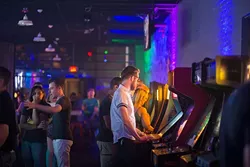 Zach Henthorn plays retro arcade games at the Flash Back Retro Pub 90's Night on Saturday, July 30, 2016 in Oklahoma City. - EMMY VERDIN