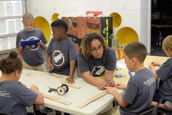 Alicia Currin-Moore helps her team build a prototype of a robotic arm during an Odyssey of the Mind practice at John Rex Elementary, Thursday, April 20, 2017. - GARETT FISBECK