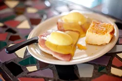 Eggs Benedict with cheese grits at Classen Grill in Oklahoma City, Friday, June 26, 2015. - GARETT FISBECK