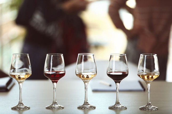 Many glasses of different wine in a row on a table. Tasting wine concept - BIGSTOCK