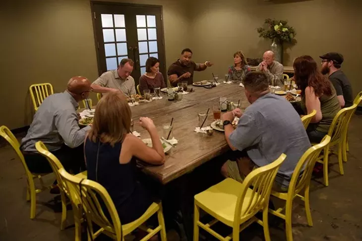 A group talks during at reconciliation dinner at Iron Star Barbecue, Tuesday, Aug. 2, 2016. - GARETT FISBECK