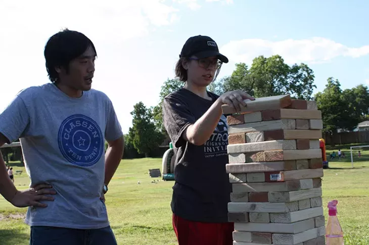 From left Matt Fong and Lacy Kelly set up a Jenga set during the recent Classen Ten Penn Community Festival at McKinley Park. | Photo Laura Eastes
