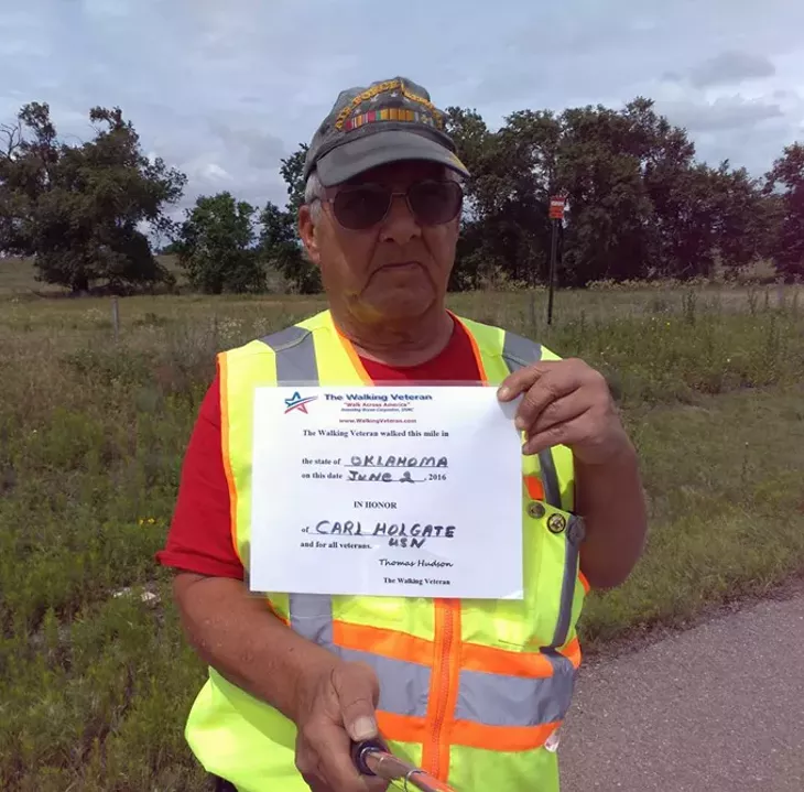 Thomas-holding-a-dedication-slip-for-when-he-walks-1-mile-in.jpg
